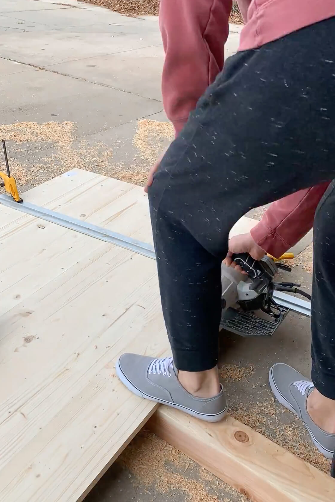 Using a circular saw to cut off the end of a DIY table.